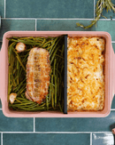 Plat ajustable Cookut en teinte Guimauve, avec séparateur breveté pour ajuster facilement la taille du plat en fonction des besoins culinaires.

